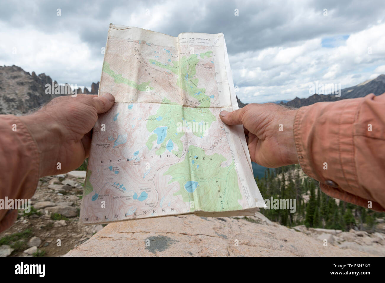 Hiker navigating by map in Idaho's Sawtooth Mountains. Stock Photo