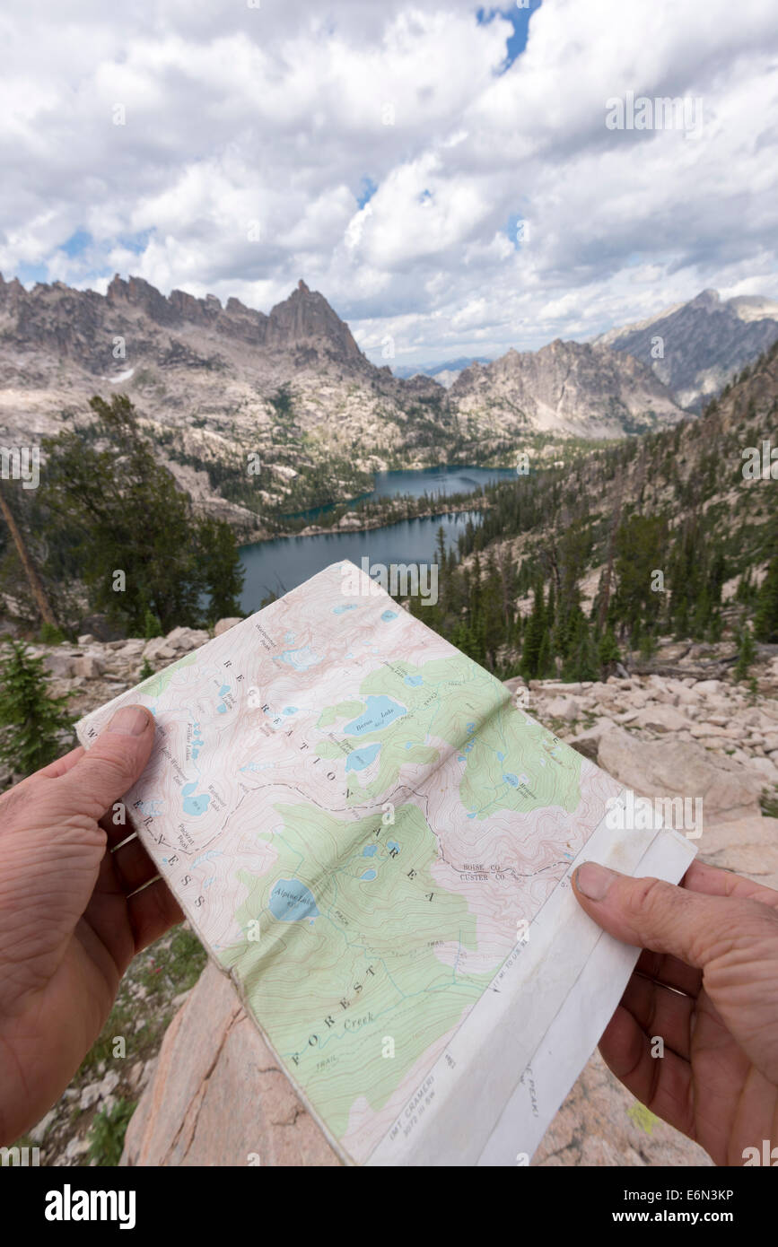 Hiker navigating by map in Idaho's Sawtooth Mountains. Stock Photo