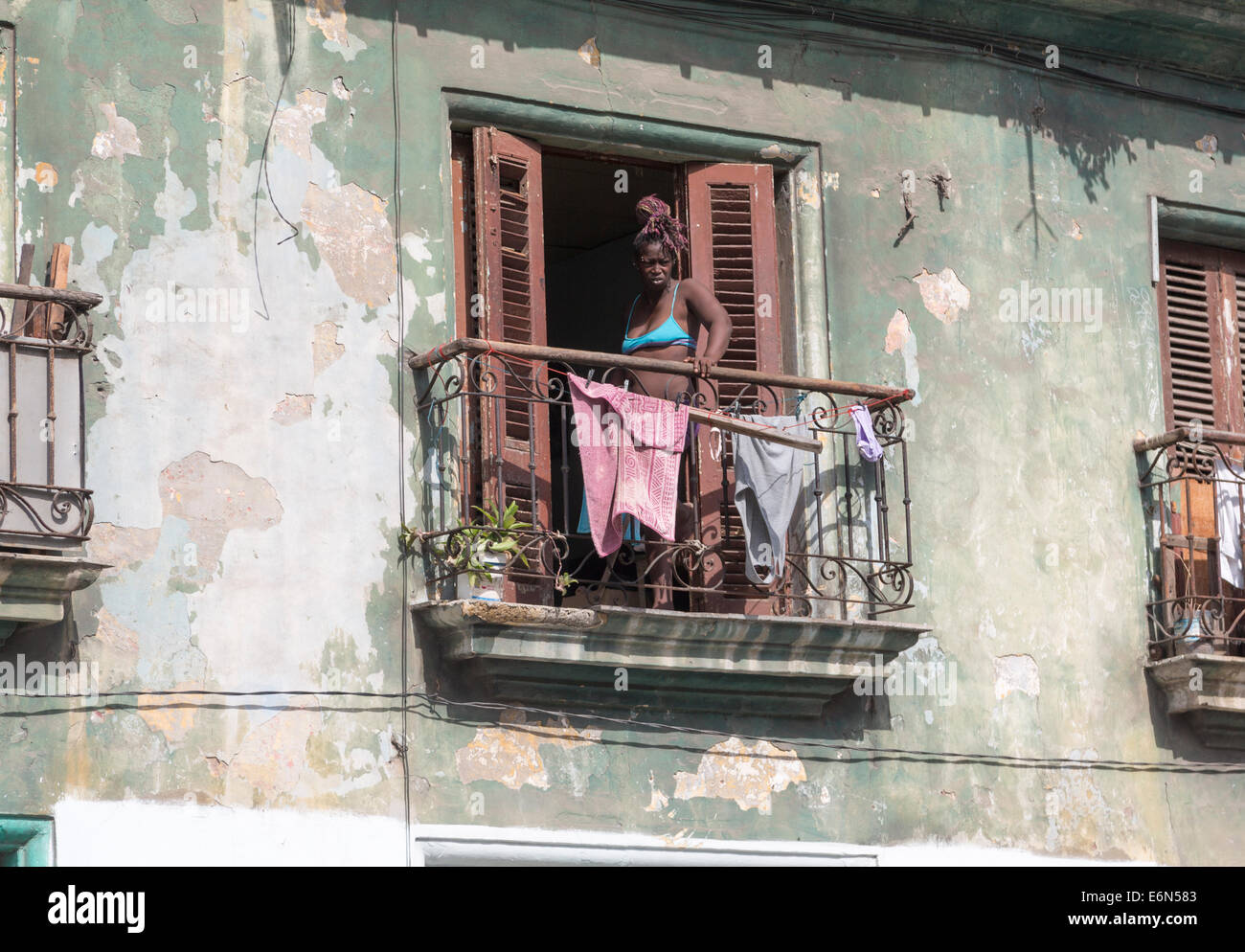 black woman with laundry on balcony, Central Havana, Cuba Stock Photo