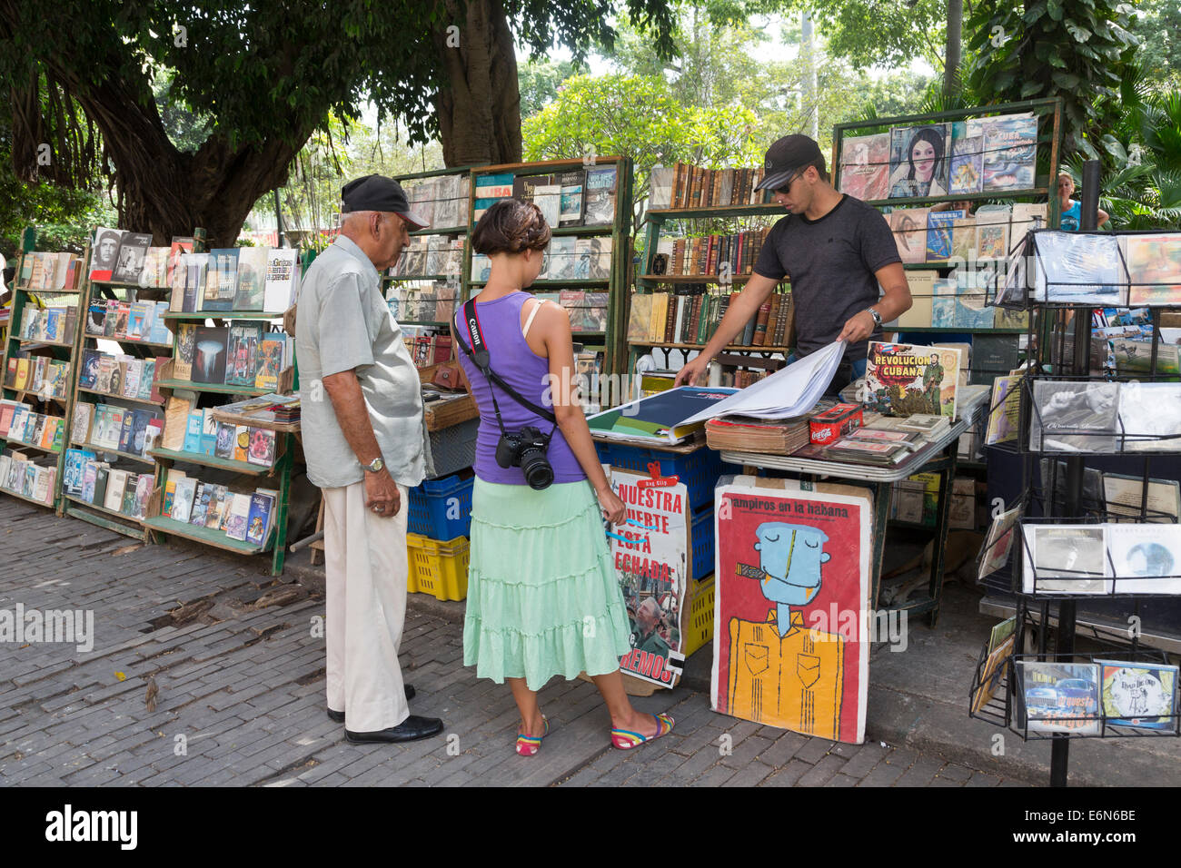tourist looking at posters for sale, Plaza de Armas, old Havana, Cuba Stock Photo