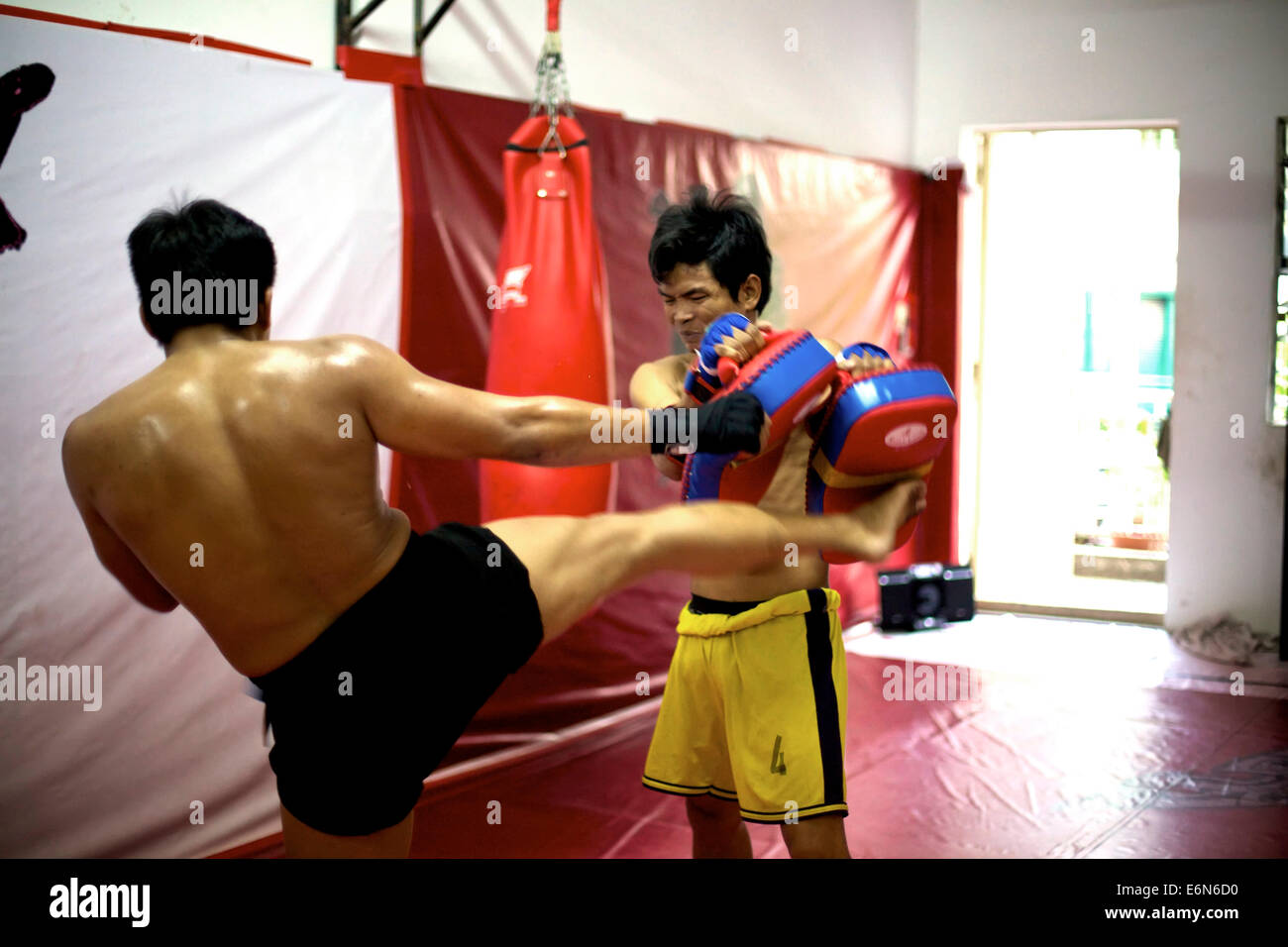Asian men training in Yuthakun Khom, traditional khmer martial arts of Cambodia. People, athletes, combat, extreme sports, gym Stock Photo