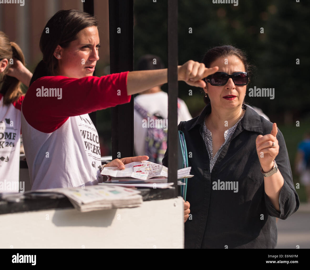 Columbus, Ohio, US. 27th Aug, 2014. OSU Junior Armelle Desiso of the Office of student Life gives directions to a fellow student during the first regular day of classes at The Ohio State University in Columbus, Ohio. Credit:  Brent Clark/Alamy Live News Stock Photo