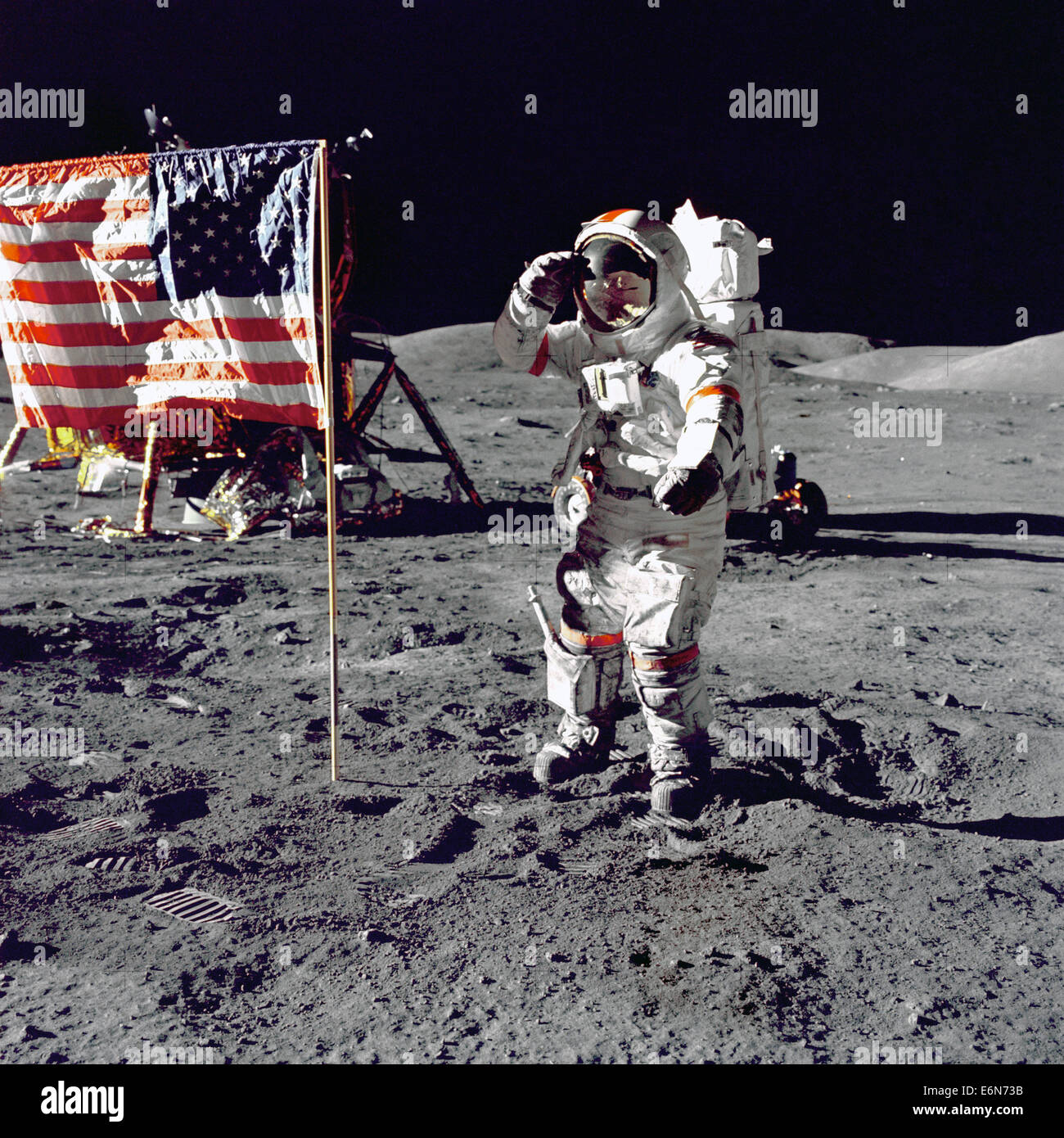 NASA astronaut Eugene A. Cernan, Commander, Apollo 17 salutes the American flag on the lunar surface during extravehicular activity in the final lunar landing mission December 13, 1972. The Lunar Module Challenger and the Lunar Roving Vehicle is in the background behind the flag. While astronauts Cernan and Schmitt descended in the Challenger to explore the Taurus-Littrow region of the Moon, astronaut Ronald E. Evans, Command Module pilot, remained with the Command/Service Module 'America' in lunar-orbit. Stock Photo