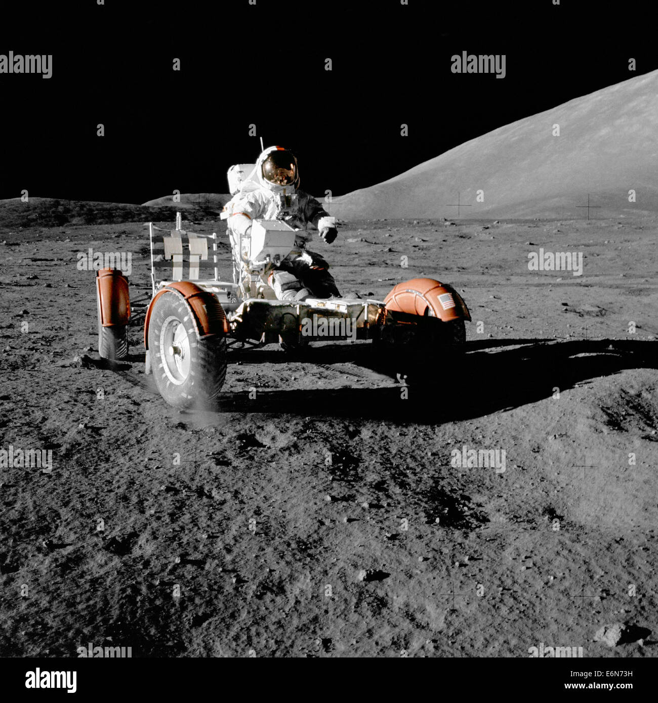 NASA astronaut Eugene Cernan, Commander, Apollo 17, tests the Lunar Roving Vehicle during the early part of the first Apollo 17 Extravehicular Activity at the Taurus-Littrow landing site December 11, 1972. This view of the stripped down LRV prior to loading up with scientific equipment. The mountain in the right background is the east end of South Massif. While astronauts Cernan and Jack Schmitt descended in the Challenger to explore the Taurus-Littrow region of the Moon, astronaut Ronald E. Evans, Command Module pilot, remained with the Command Service Module 'America' in lunar-orbit. Stock Photo