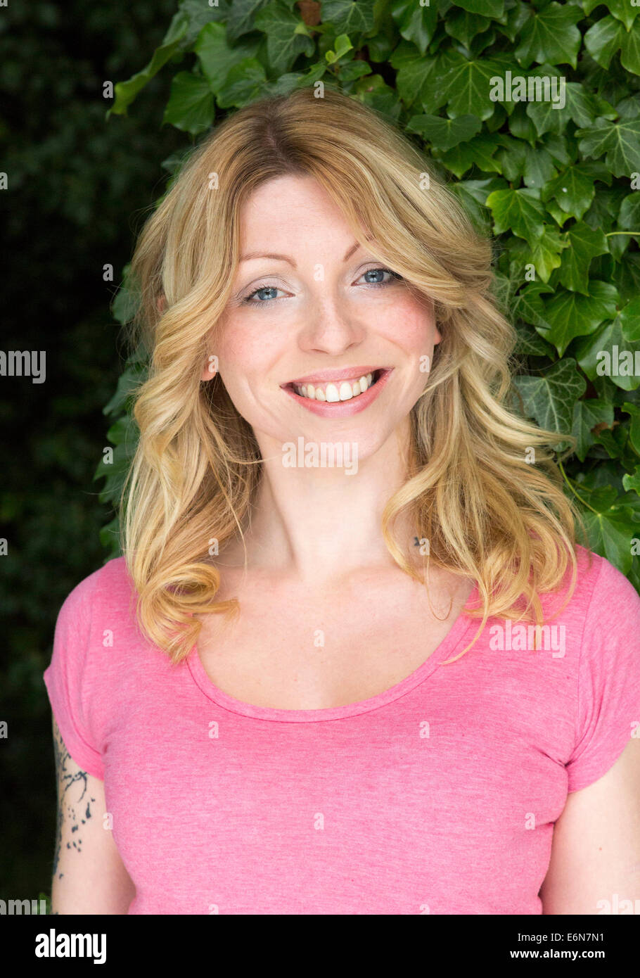 portrait of smiling young woman outdoors Stock Photo