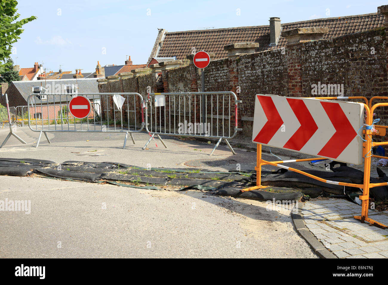 Road closed barriers and sand bags for flooding in Rue Anguier du Peuple, St Valery Sur Somme, Somme, Picardy France Stock Photo