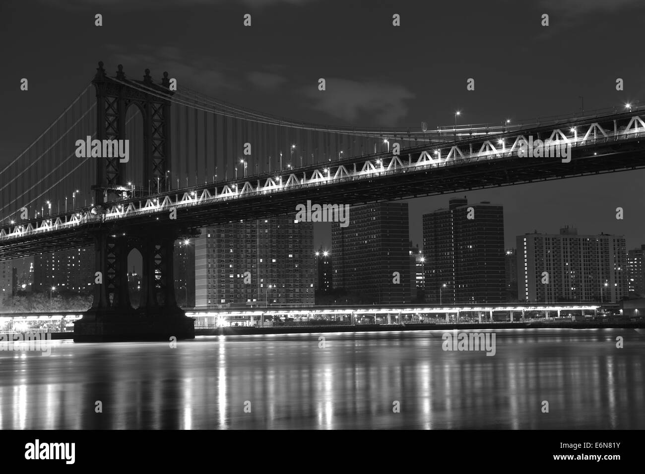 Manhattan Island and Brooklyn Bridge in the summer night in New York. Photo was shot from Brooklyn's side. Stock Photo