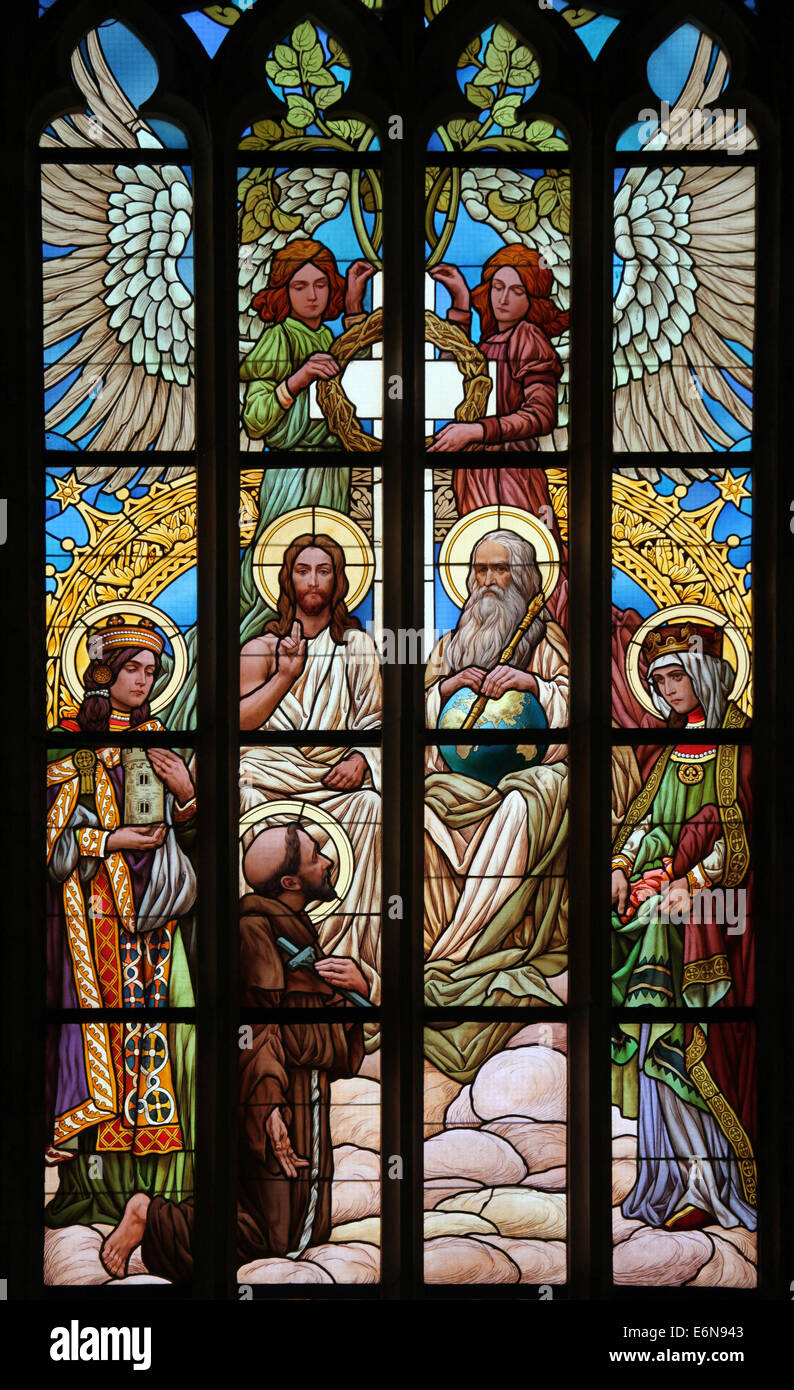 The Holy Trinity. Stained glass window in Saint Barbara's Church in Kutna Hora, Czech Republic. Stock Photo