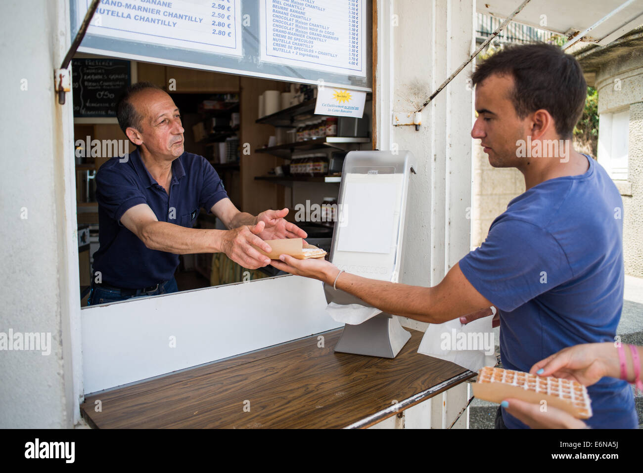 People shopping for waffles and crepes, Dinard, near Saint Malo,  France Stock Photo
