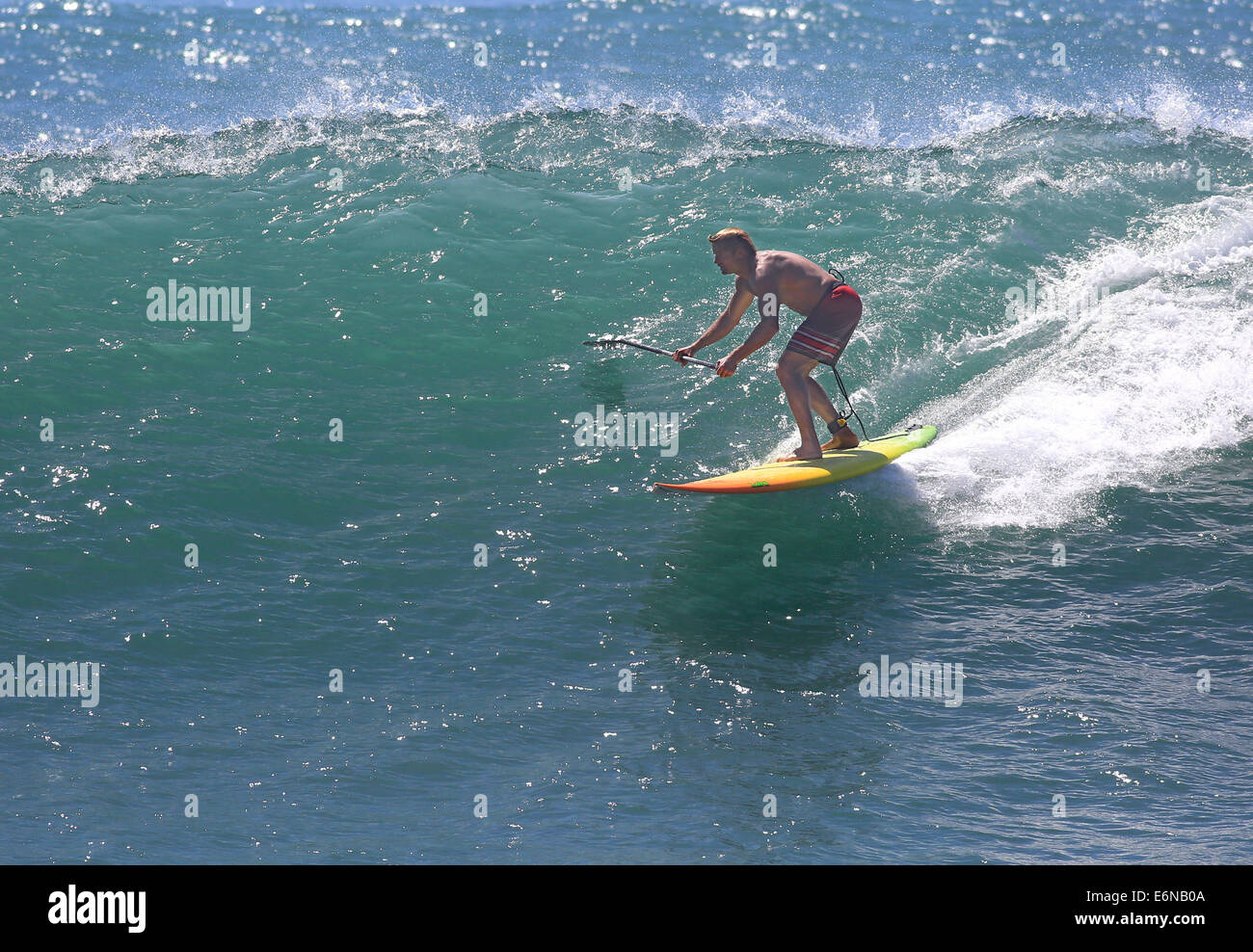 Malibu, California, USA. 27th Aug, 2014. Professional surfer Laird Hamilton rides a wave in Malibu at Surfrider beach as big waves swelled by distant Hurricane Marie arrives at Southern California beaches. Credit:  ZUMA Press, Inc./Alamy Live News Stock Photo