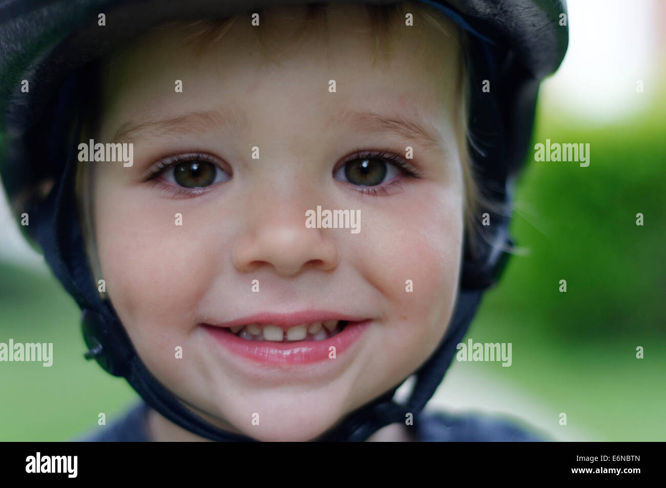 A portrait of a beautiful young boy wearing a cycle helmet Stock Photo