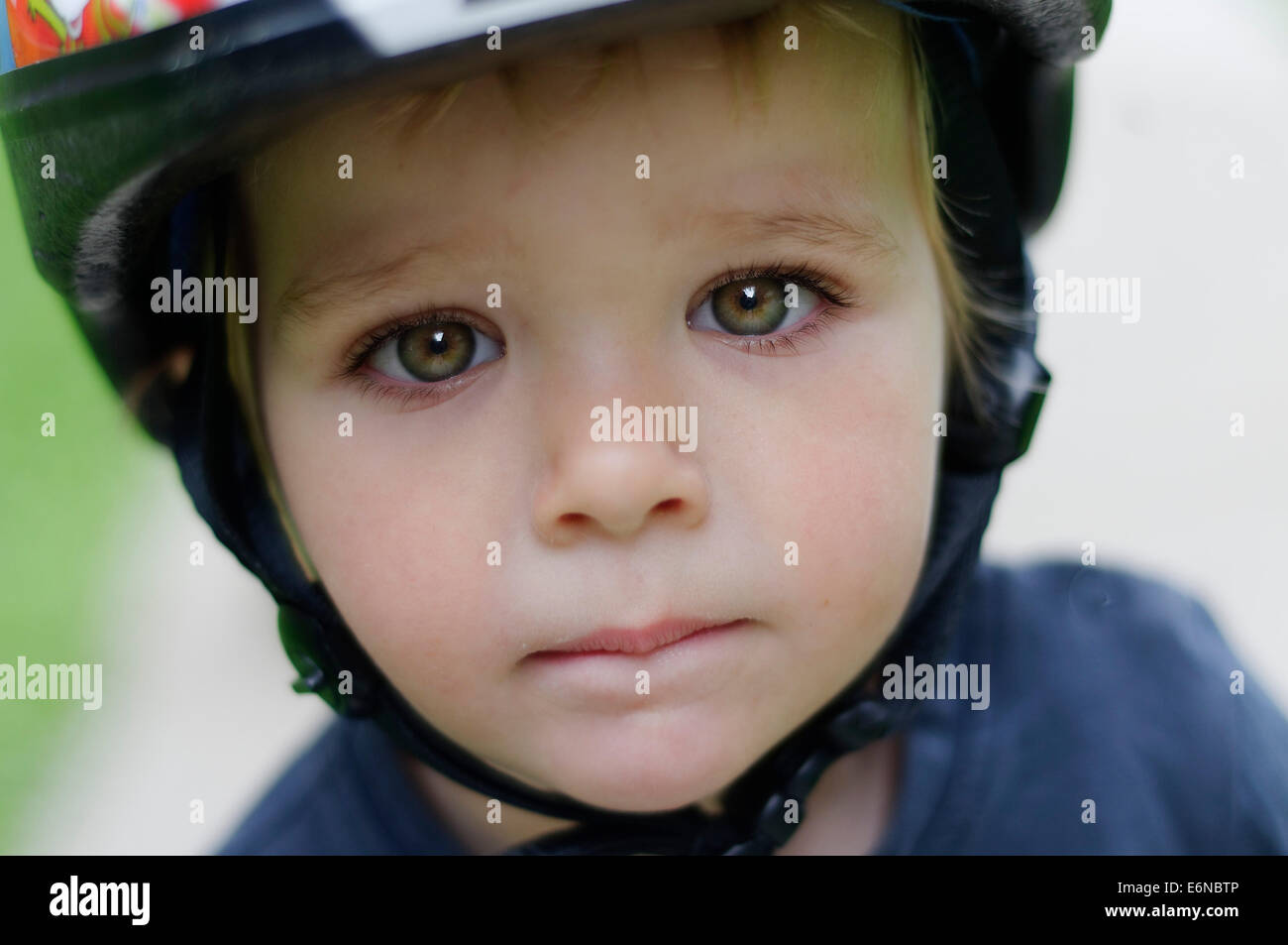 A portrait of a beautiful young boy wearing a cycle helmet Stock Photo