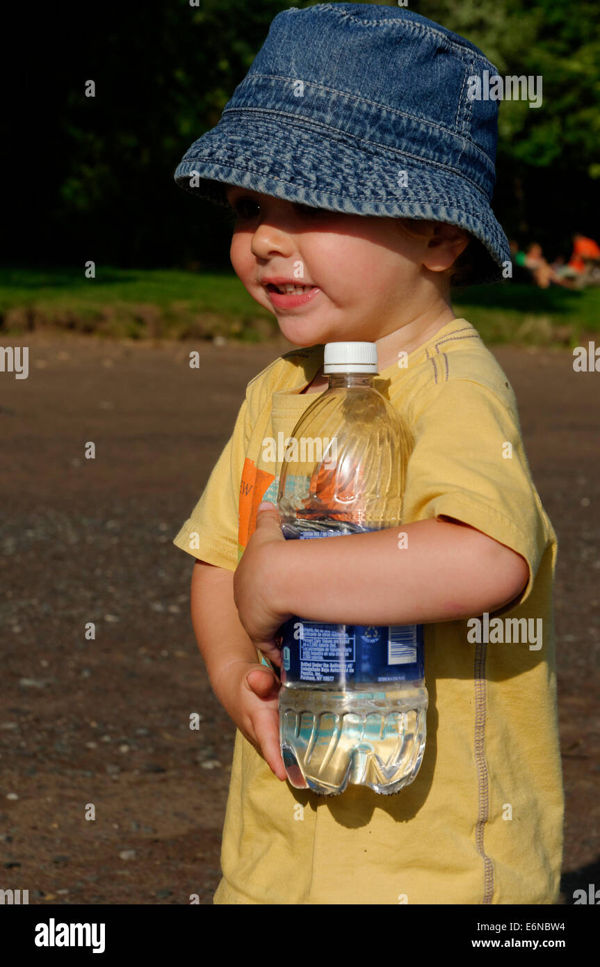 https://c8.alamy.com/comp/E6NBW4/a-young-boy-carrying-a-plastic-water-bottle-E6NBW4.jpg
