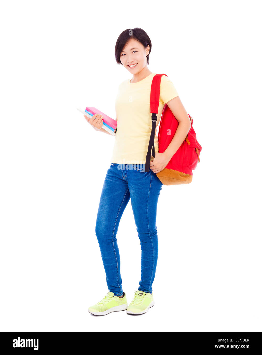 smiling young student girl standing and holding book Stock Photo - Alamy