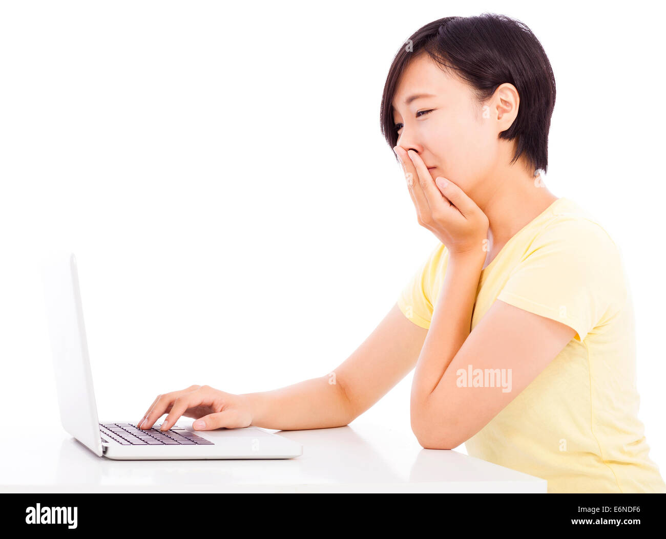 crying woman in front of a laptop, isolated on white background Stock Photo