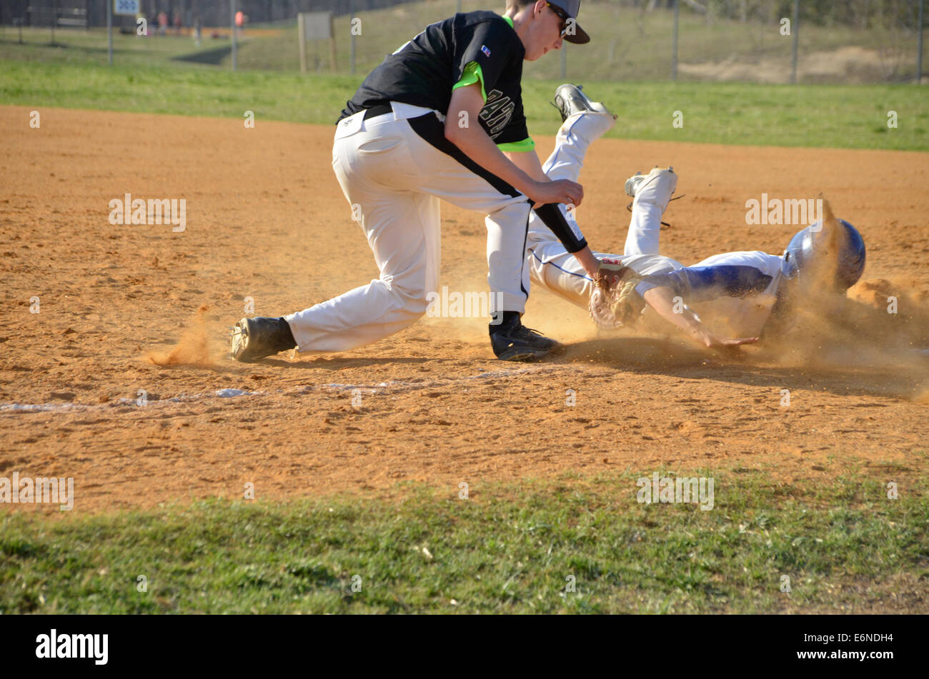 player slides into a base in a baseball game Stock Photo
