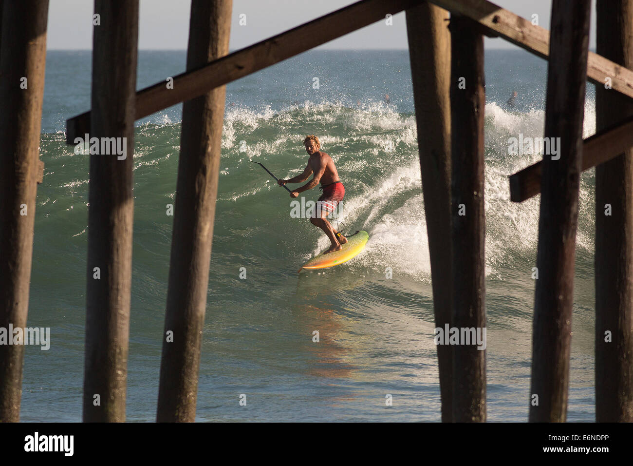 Malibu, California, USA. 27th Aug, 2014. Professional surfer Laird Hamilton shoots the pier at Malibu Surfrider beach as big waves swelled by distant Hurricane Marie arrives at Southern California beaches. © Jonathan Alcorn/ZUMA Wire/Alamy Live News Stock Photo