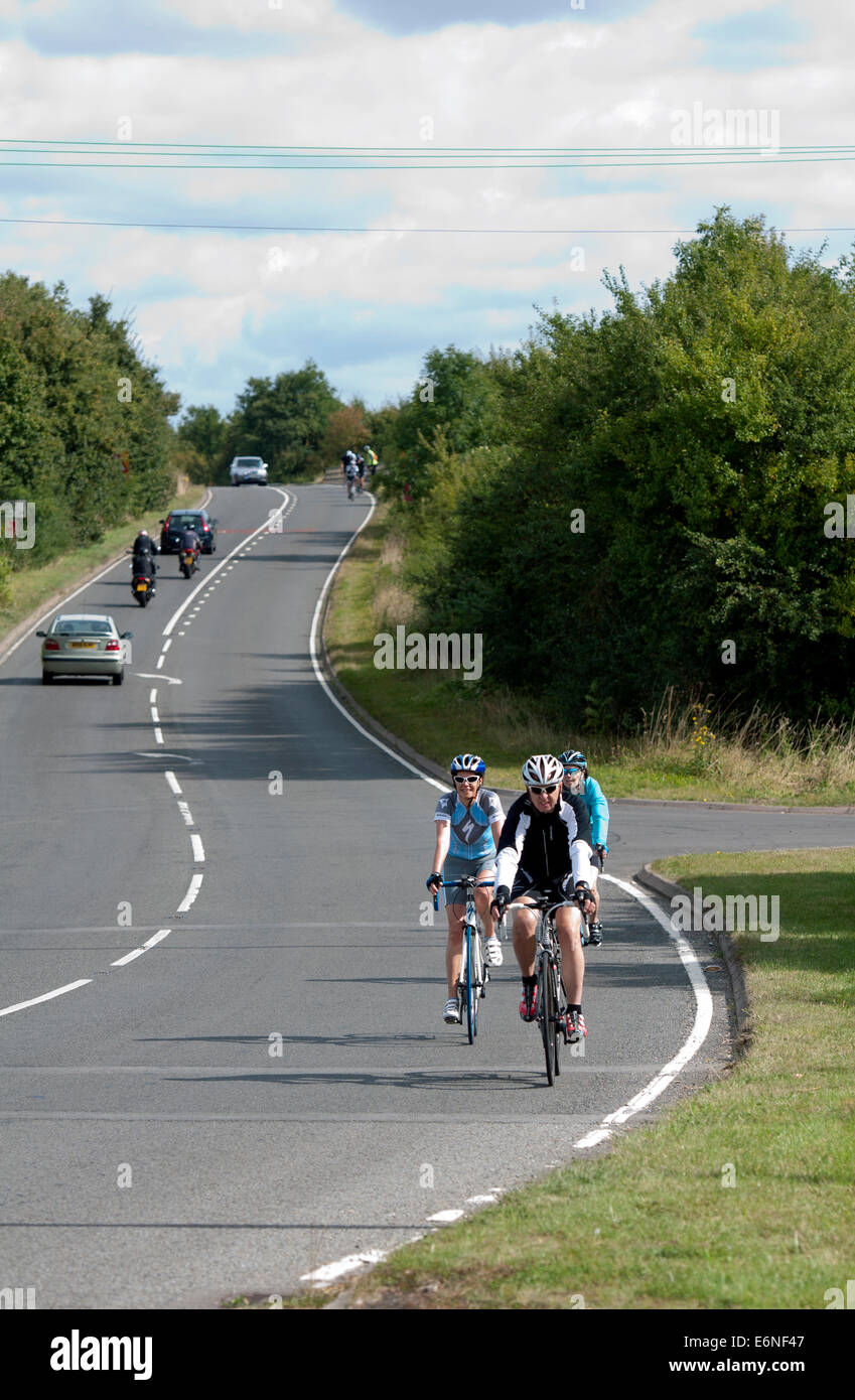 Cyclists on the Fosse Way road, Warwickshire, UK Stock Photo