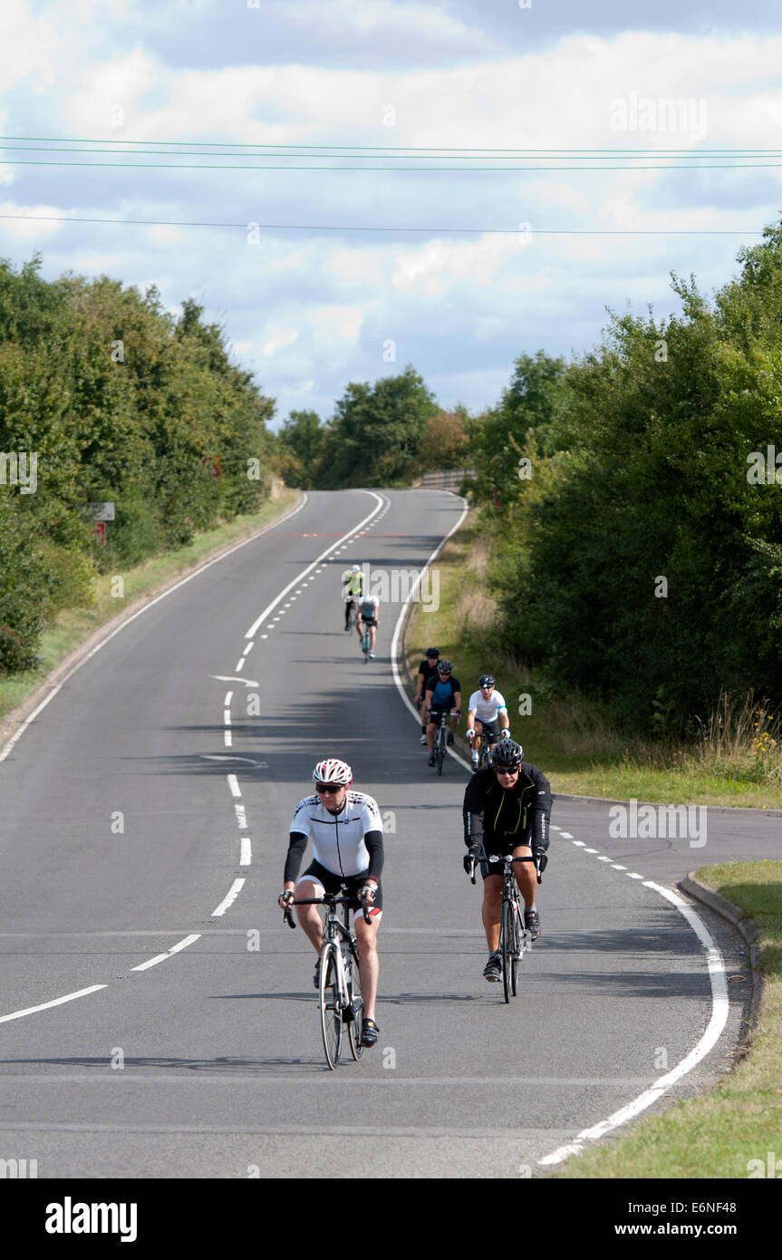 Cyclists on the Fosse Way road, Warwickshire, UK Stock Photo
