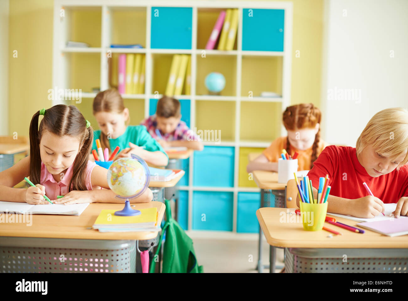 Group of schoolchildren drawing at lesson Stock Photo - Alamy