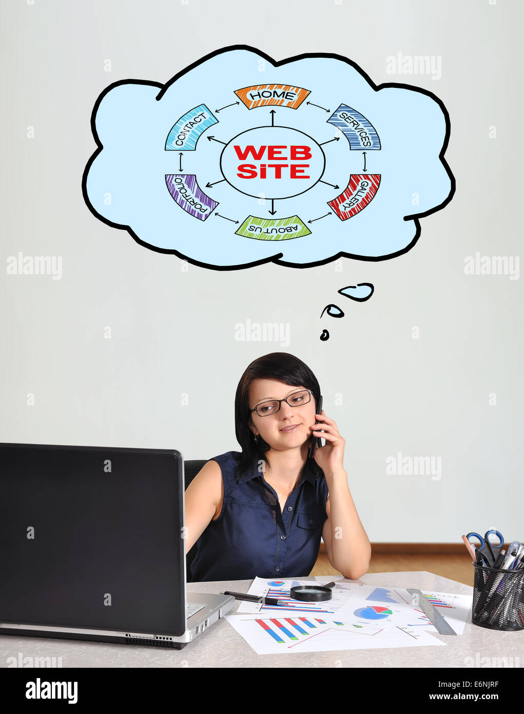happy businesswoman sitting in office and scheme website Stock Photo