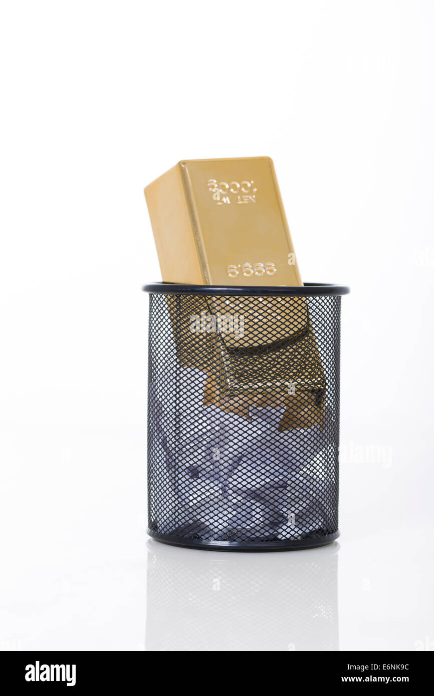 Ingot in wastepaper basket Stock Photo