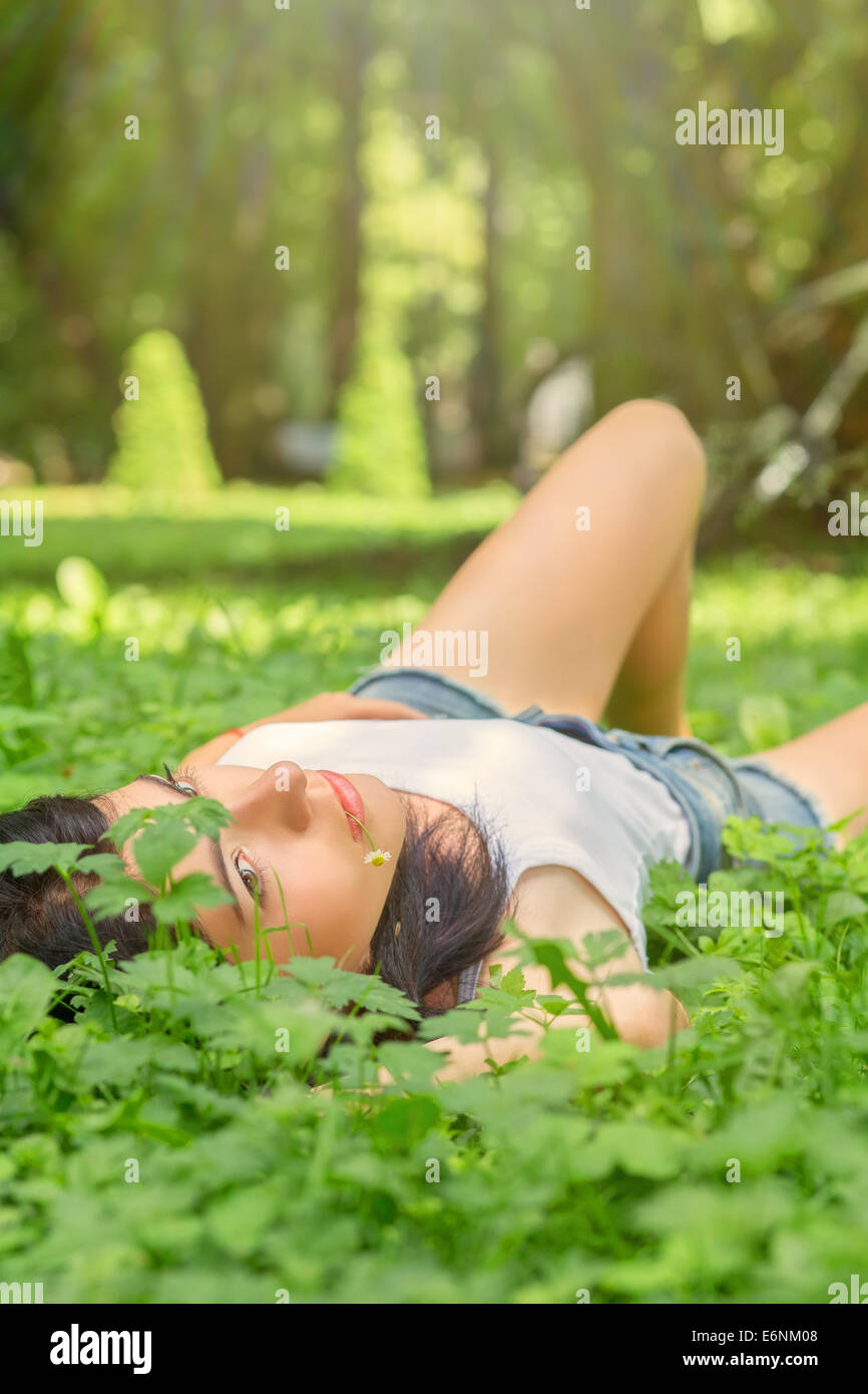 pretty young woman lying in grass Stock Photo - Alamy