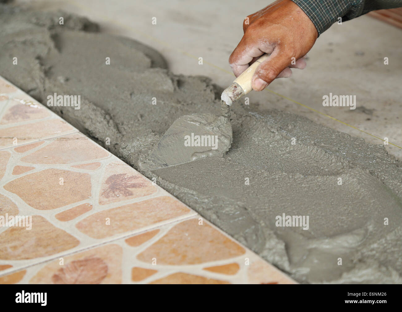 renovation handyman laying tile, trowel with mortar Stock Photo Alamy