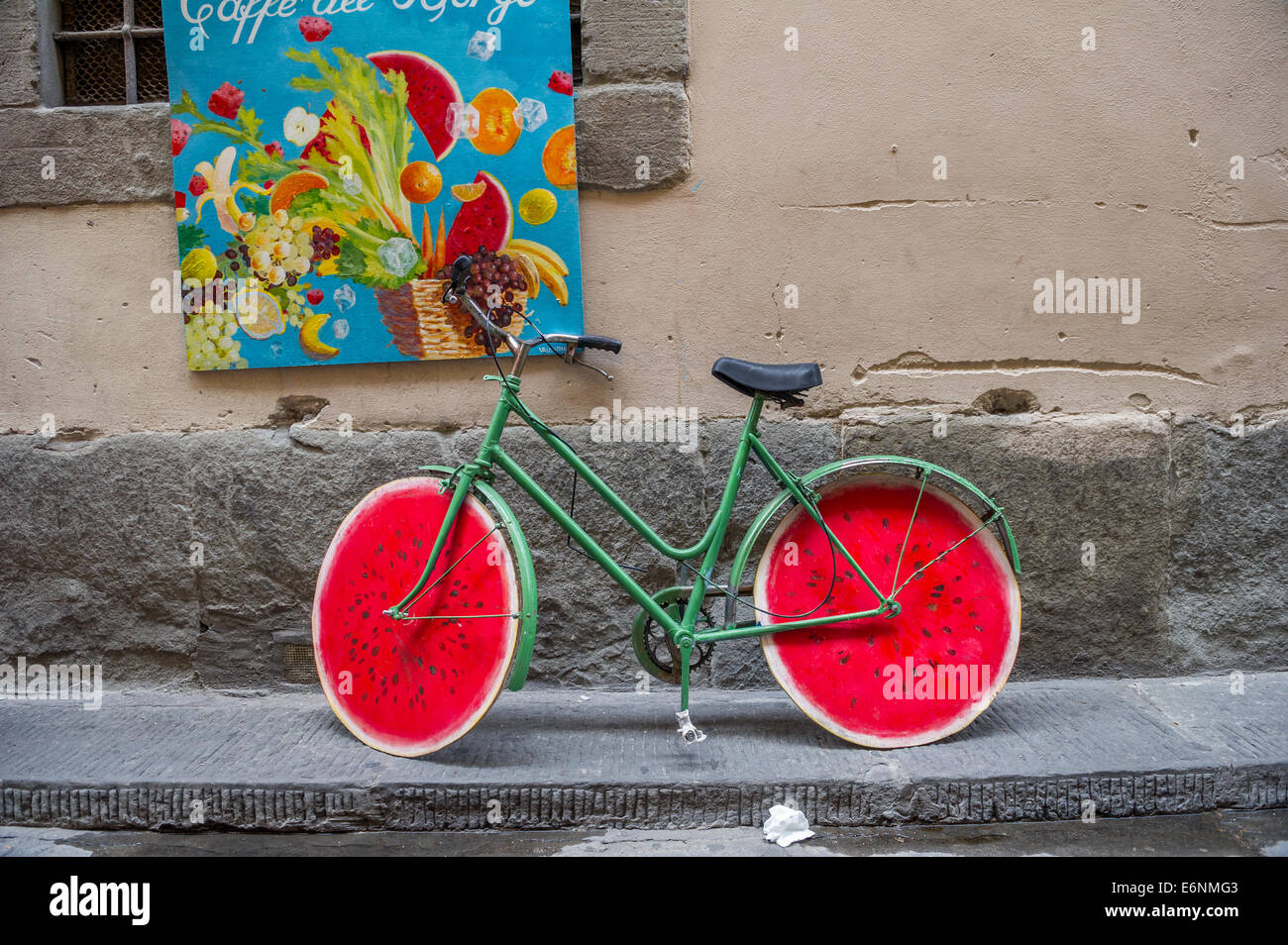 Green cycle with red coloured wooden wheels in the form of a water melon. Stock Photo