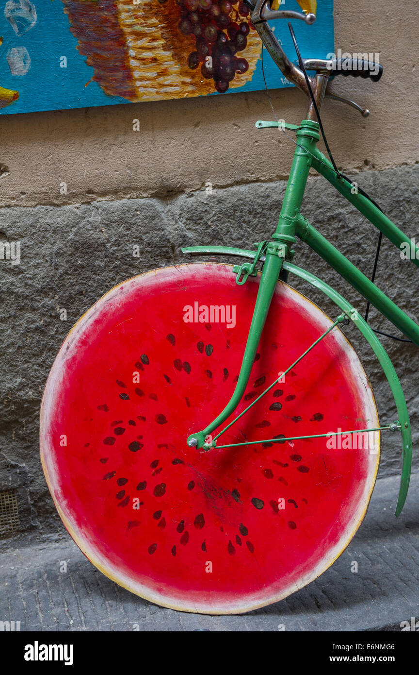 Green cycle with red coloured wooden wheels in the form of a water melon. Stock Photo