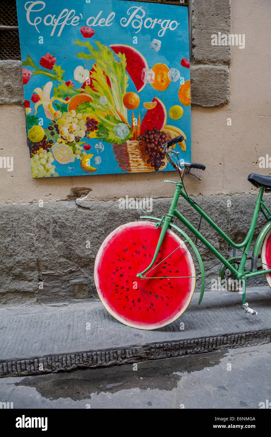 Green cycle with red coloured wooden wheels in the form of a water melon. Stock Photo