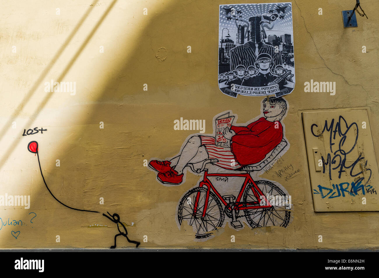 Political slogans and graffiti on a yellow wall in Florence, Italy. Stock Photo