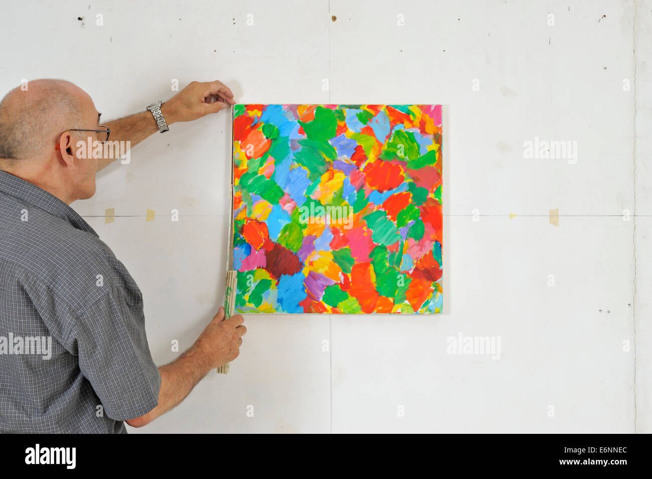 French Painter Michel Gentil hanging his painting at workshop Stock Photo