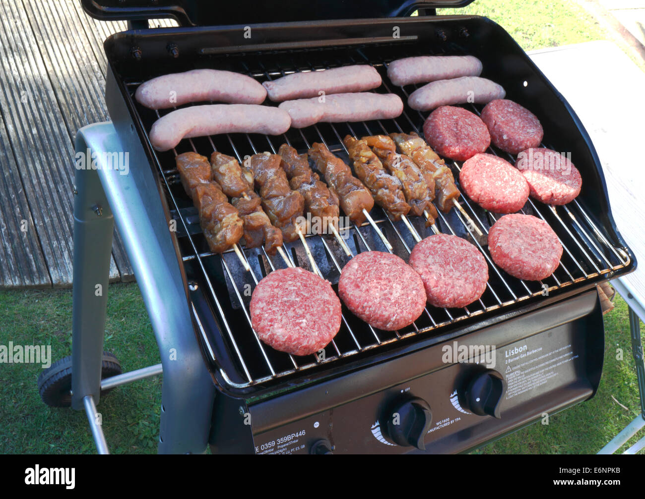 A gas burner BBQ loaded with fresh food ready for cooking Stock Photo
