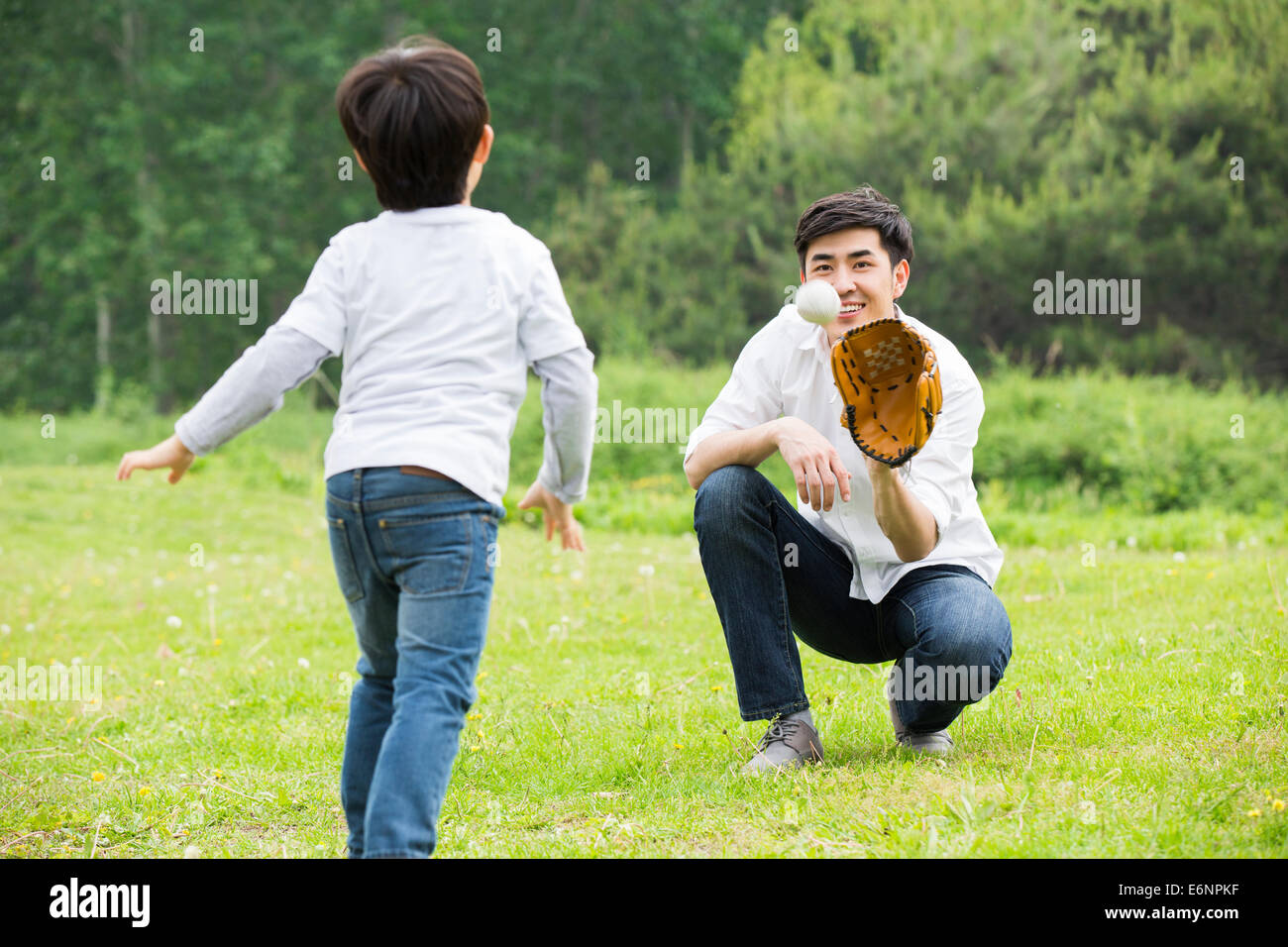 Father and son playing baseball Stock Photo