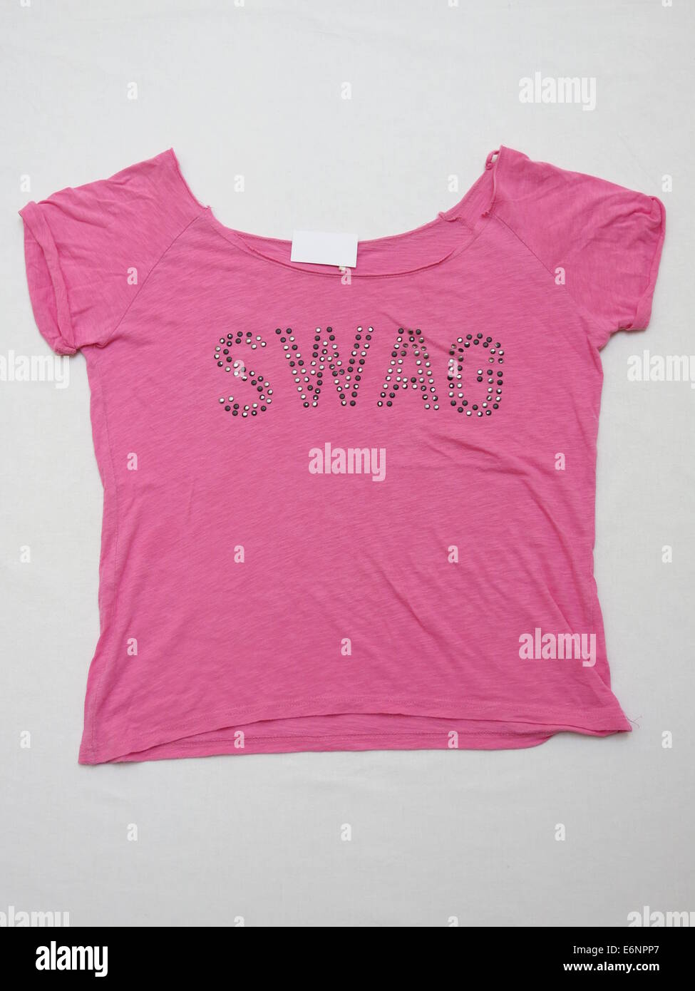 Girl's top with Swag print on it, isolated against white background. Stock Photo