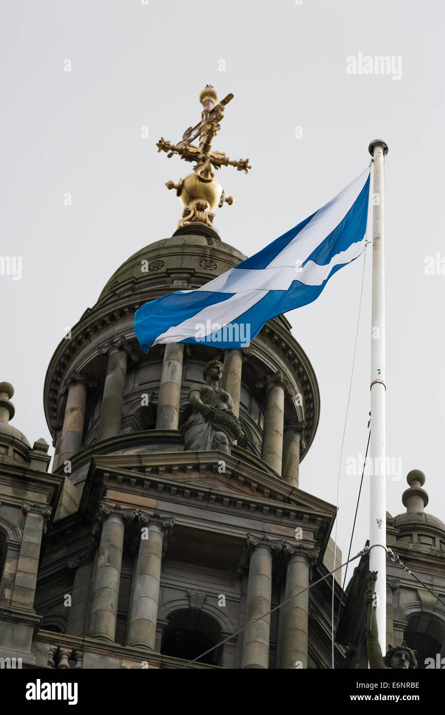 Scotland Flag flying on a pole with with wire supports above Glasgow