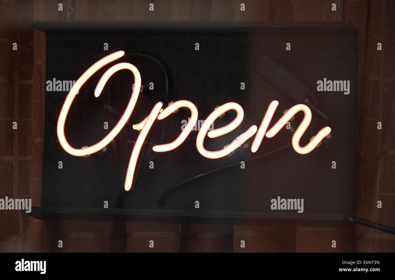 A neon open sign in the window of a store Stock Photo