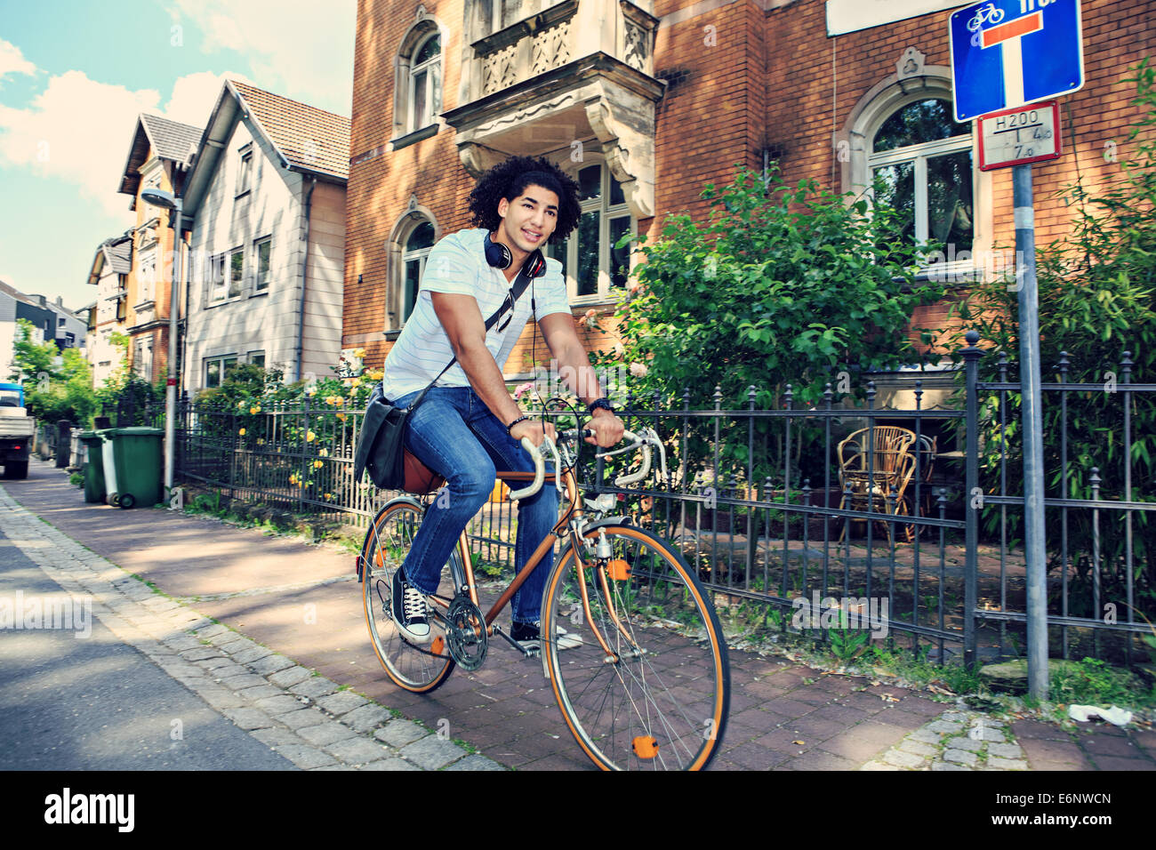 portrait of young male student with a bicycle in the town Stock Photo