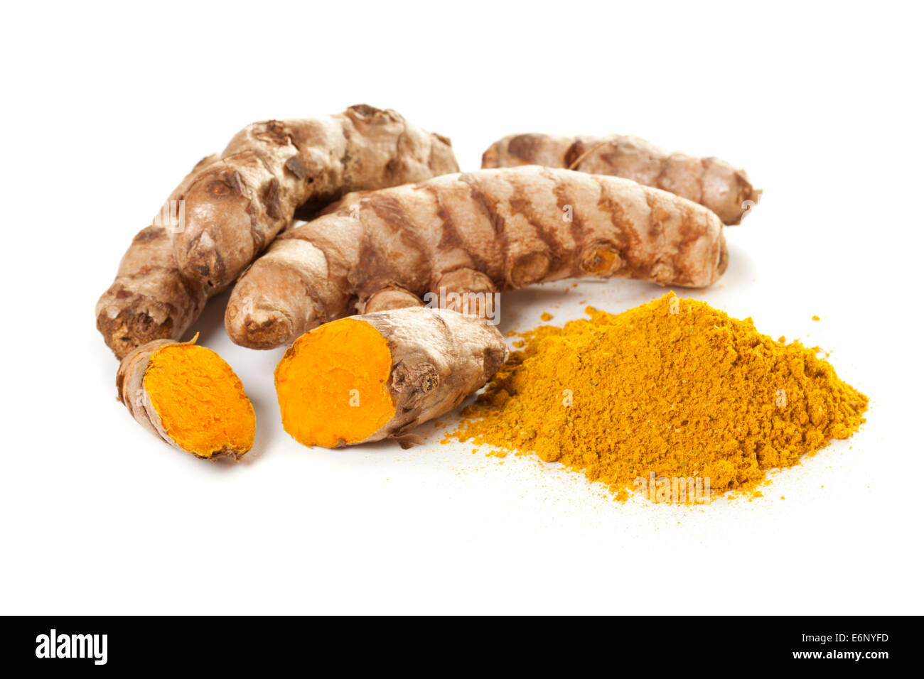 Heap of ground turmeric and turmeric roots on white background Stock Photo