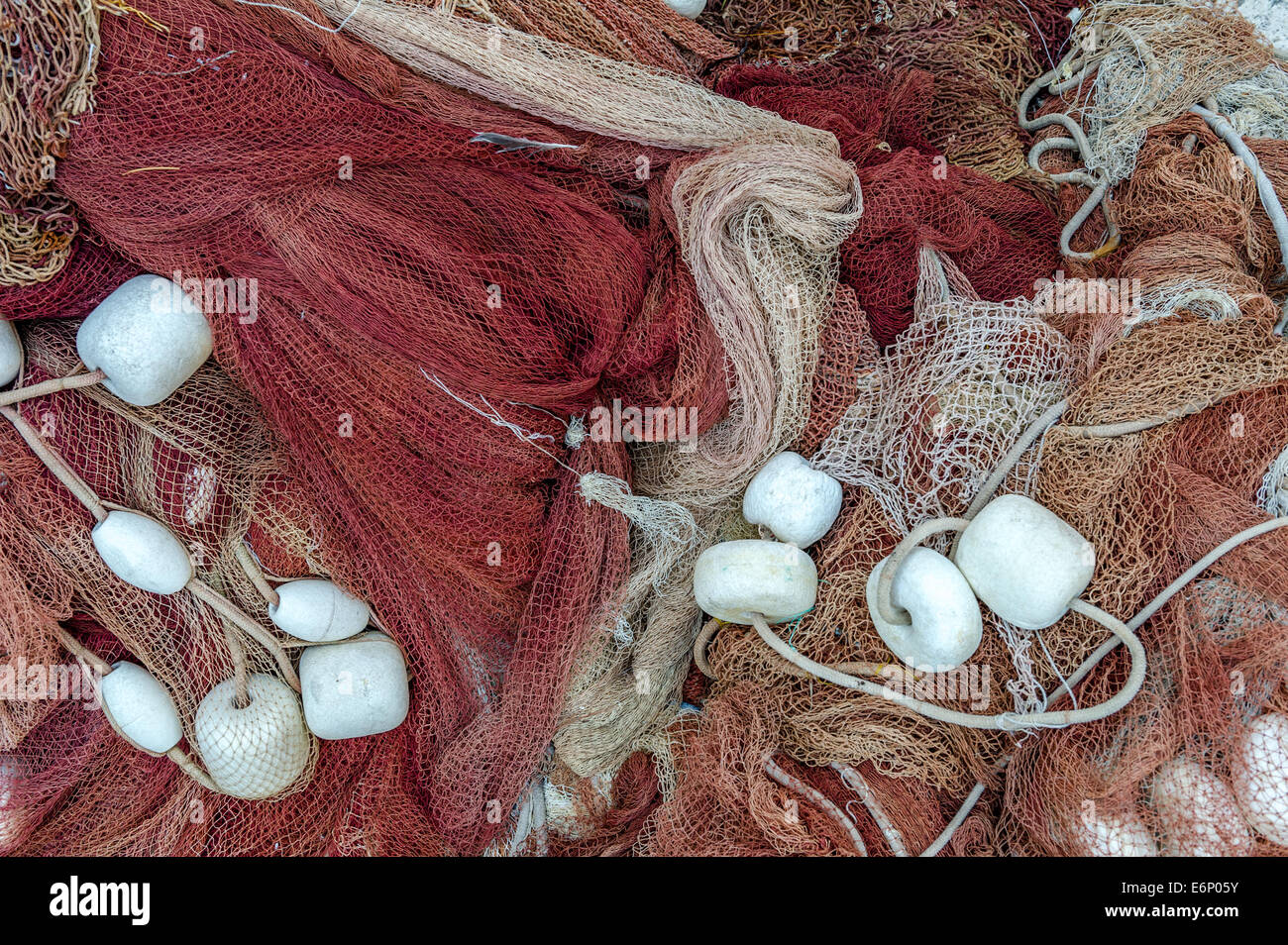 Fishing nets with small white stones. Stock Photo