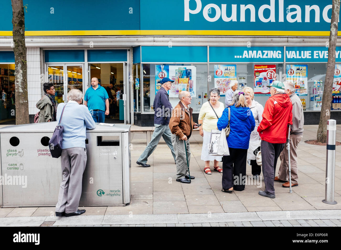 Old people chatting in street outside a Poundland store. Stock Photo