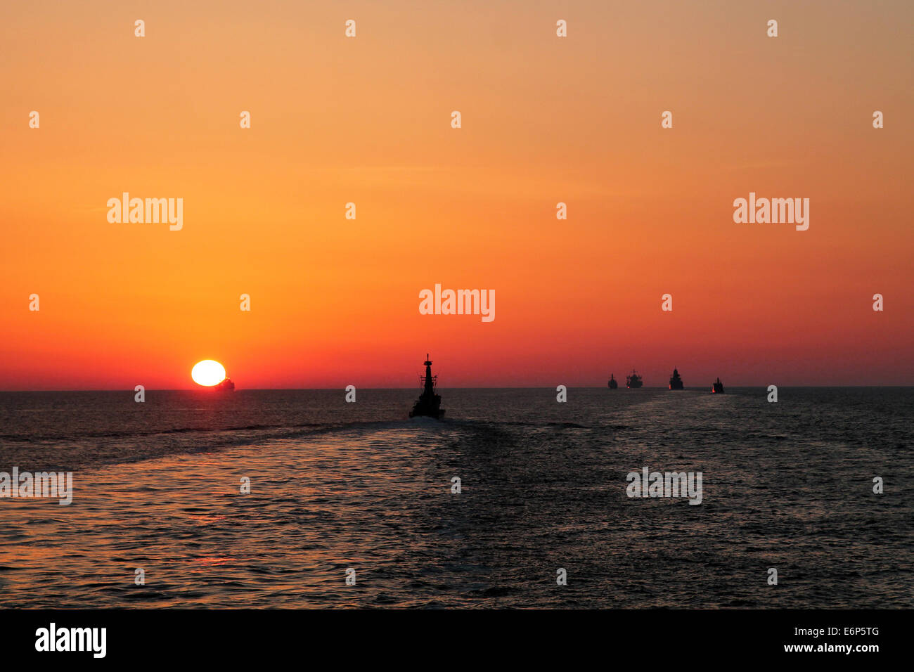 Ships in BALTOPS 2014 naval exercise at sunset in the middle of Baltic Sea, june 2014. Stock Photo