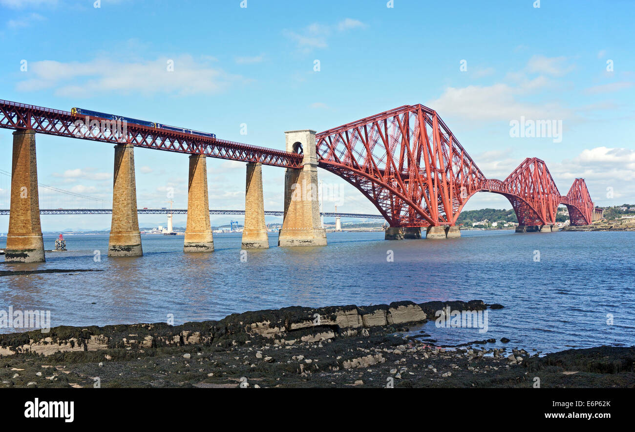 The Forth Bridge From east of South Queensferry in Edinburgh Scotland connecting rail services with Fife with train passing over Stock Photo