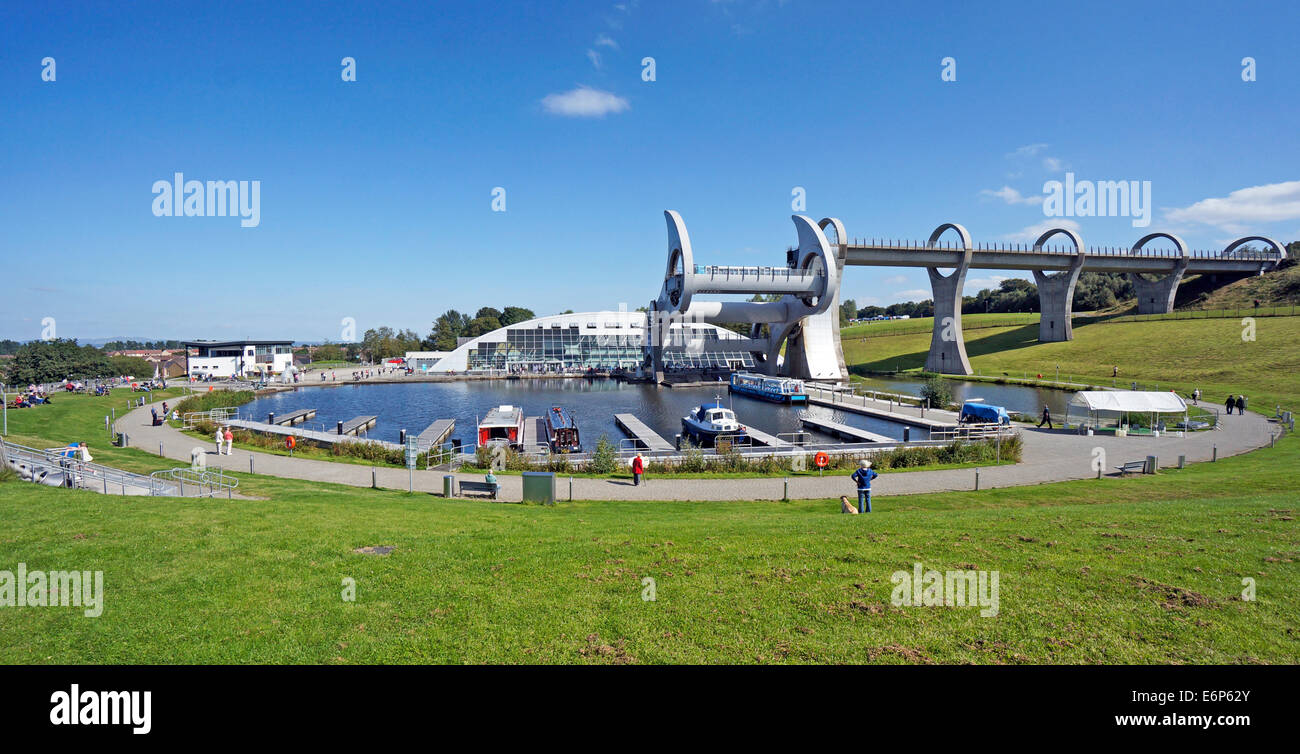 A general view of the Falkirk Wheel tourist attraction in Falkirk Scotland UK with the wheel turning and boats moored in the canal basin Stock Photo