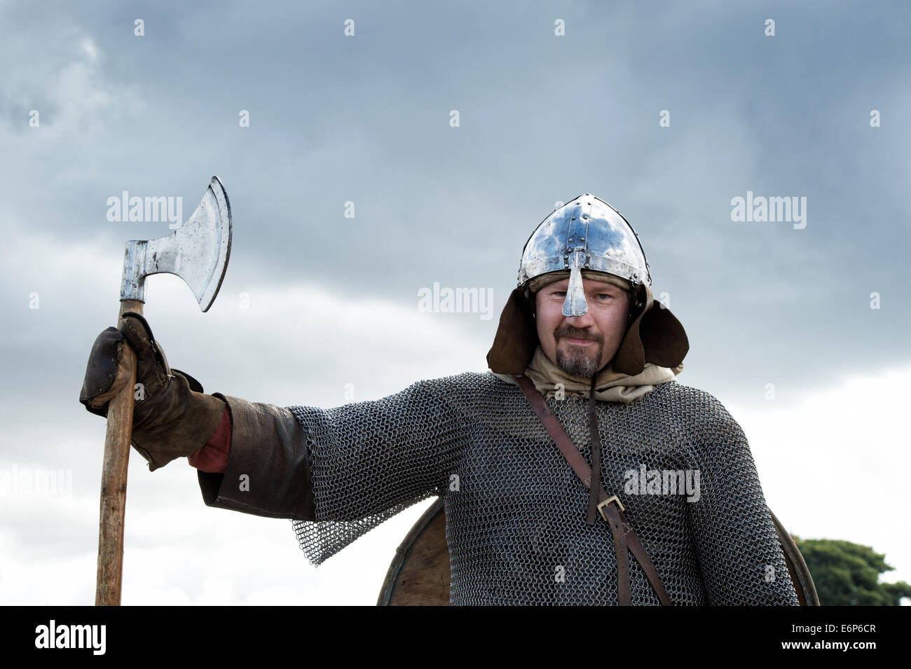 Viking wearing armor and carrying an axe at a historical reenactment. UK Stock Photo