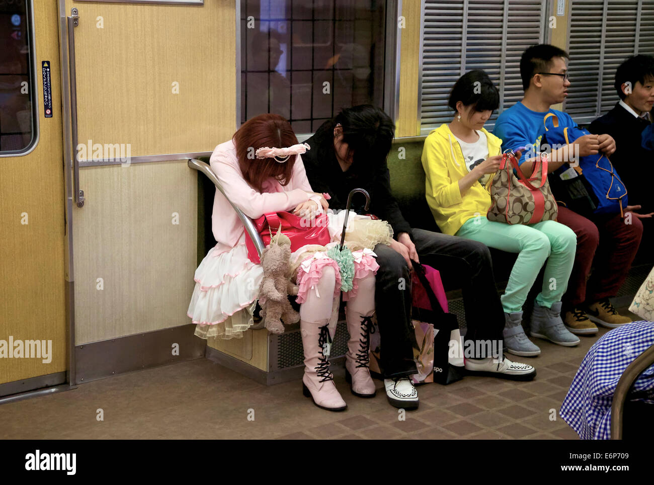 Young japanese people sleeping, traveling on subway train. Japan, Asia Stock Photo