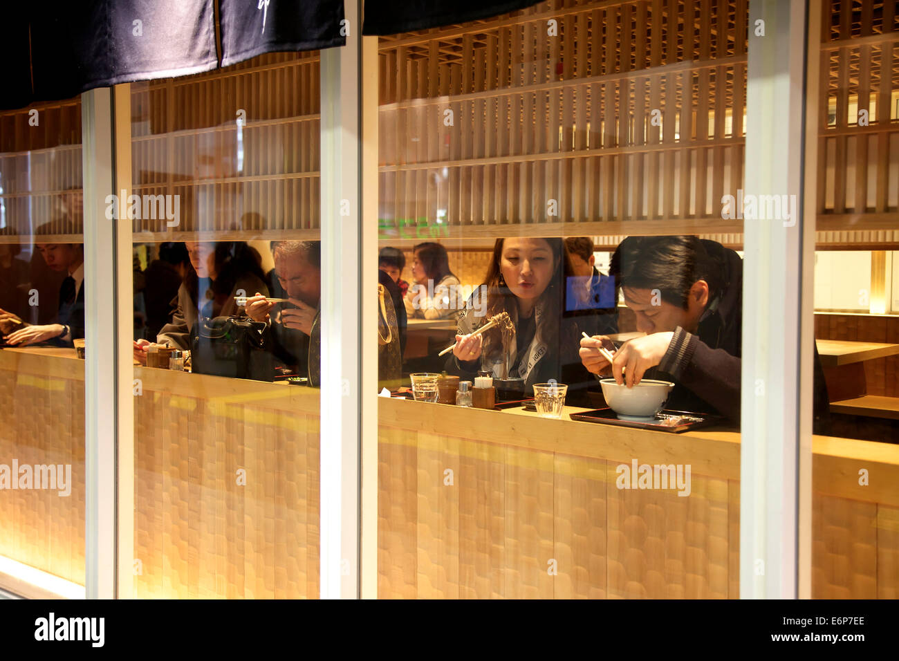 Japanese people eating noodle soup in restaurant. Tokyo, Japan, Asia Stock Photo