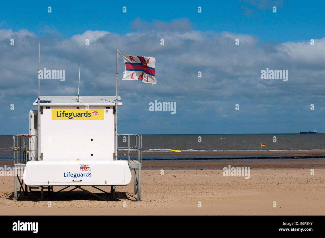 Lifeguard station flying RNLI flag, on a deserted British beach Stock
