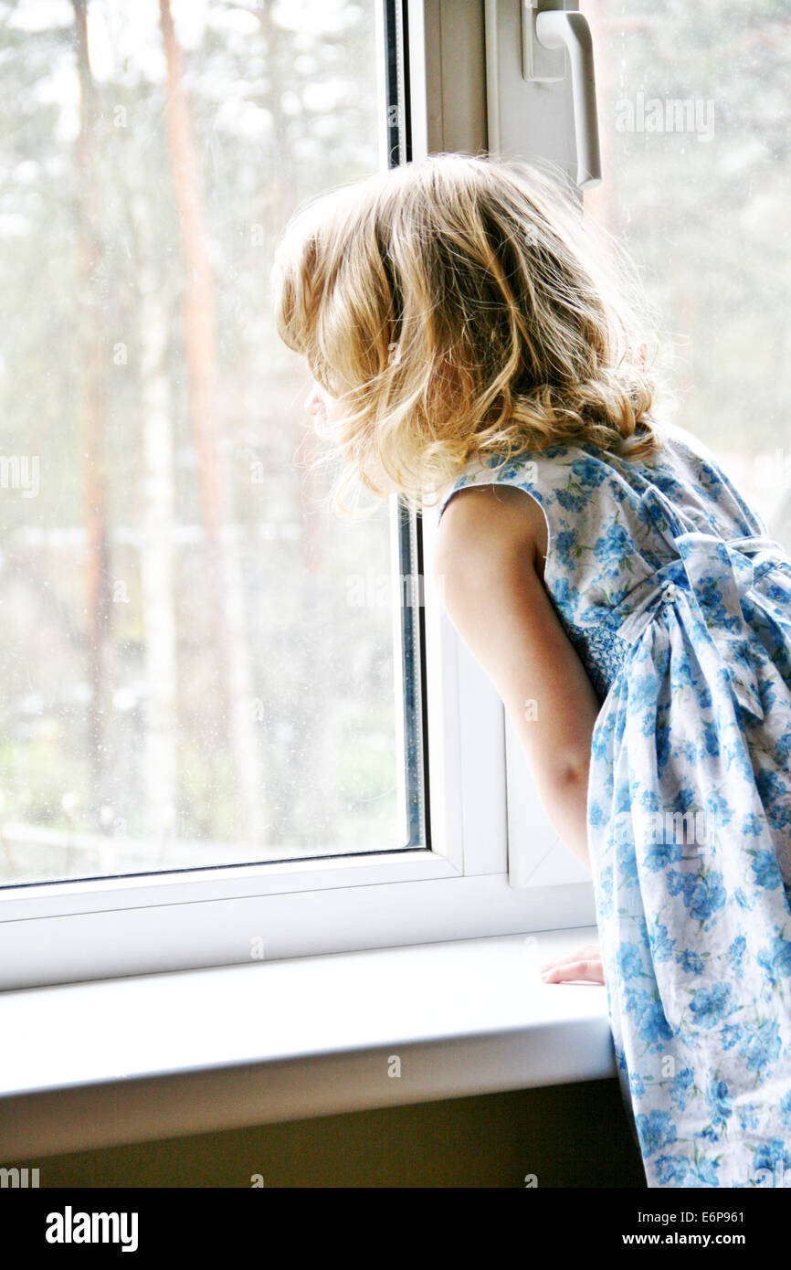 A girl looking out of the window. Fairytale Stock Photo